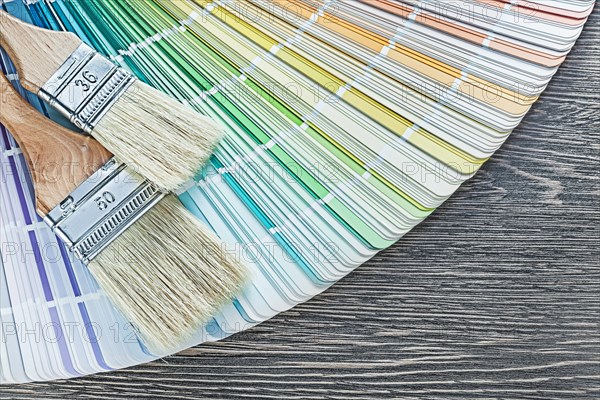 Composition of color palette paintbrushes on wooden board