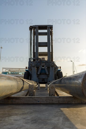 Forklift lowers a boat into the water at a marina