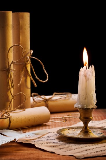 Burning candle and antique items