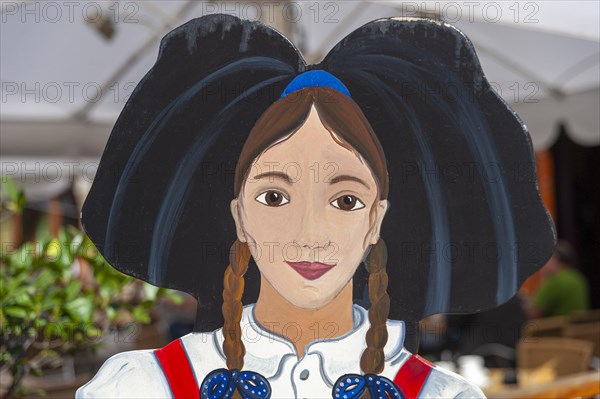 Wooden figure of a woman in traditional traditional costume