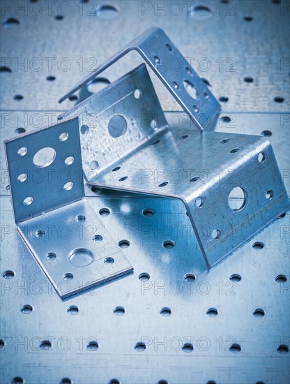 Stainless drilled angle fasteners on perforated sheet metal construction concept