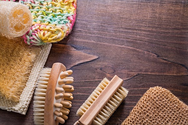 Bath sticks loofah massagers on vintage wooden board with copy area