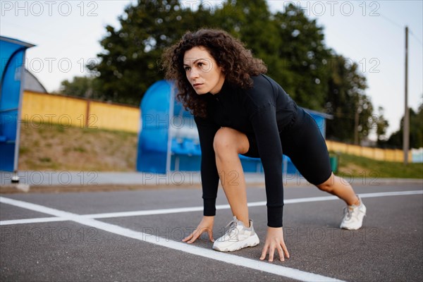 Curly girl runner is engaged in athletics