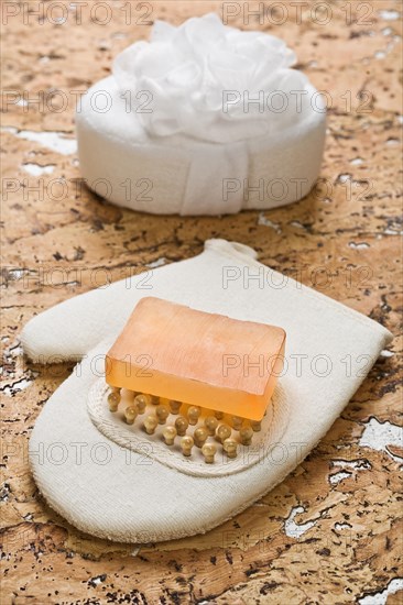 Bath sponge and soap on cork wood