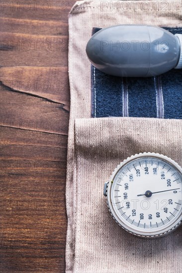 Blood pressure monitor on vintage wooden board close up medical concept