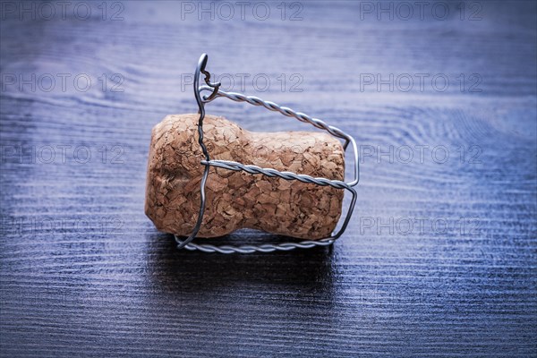 Close up corck of champagne and wire on board