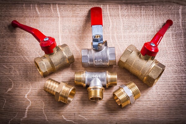 Composition Of Plumbing Tools Brass Pipe Connectors On Wooden Board
