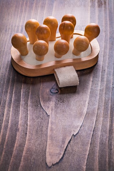Classic wooden massager on vintage board