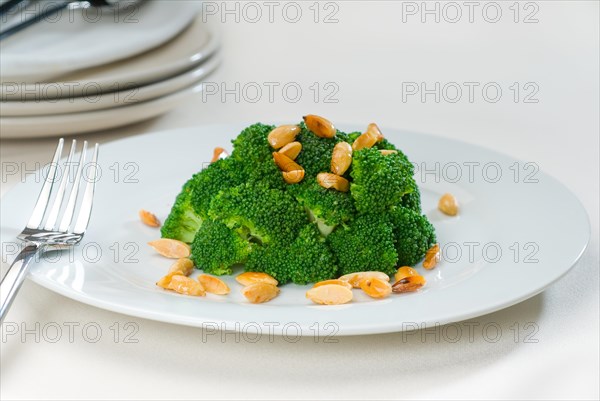 Fresh and vivid sauteed broccoli and almonds very ealthy food