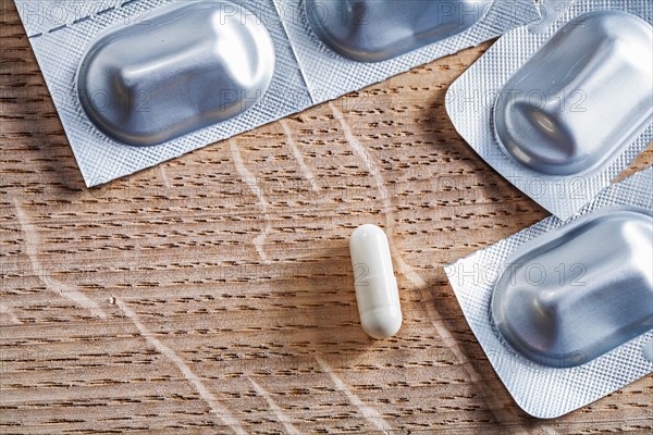 Pills on an old wooden board