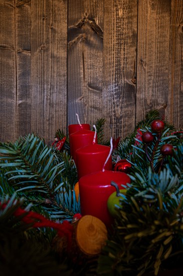 Red Advent candles on a festive Advent arrangement