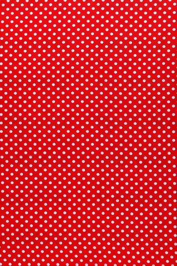 Red polka-dot cotton fabric vertical view