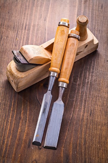 Plane and chisel on an old wooden board