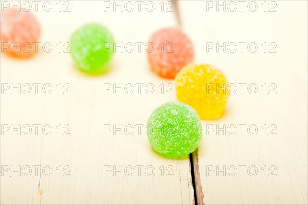Sugar jelly fruit candy over white wood table