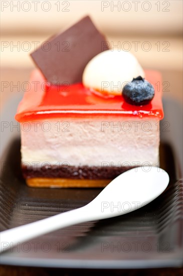 Fresh strawberry yogurt mousse with macaroon and blueberry on top