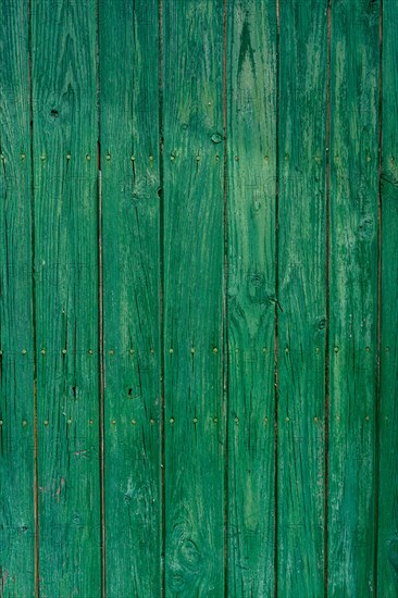Old wooden door with aged metal door handle. Architectural textured background