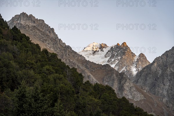 Glaciated mountain peak at sunset