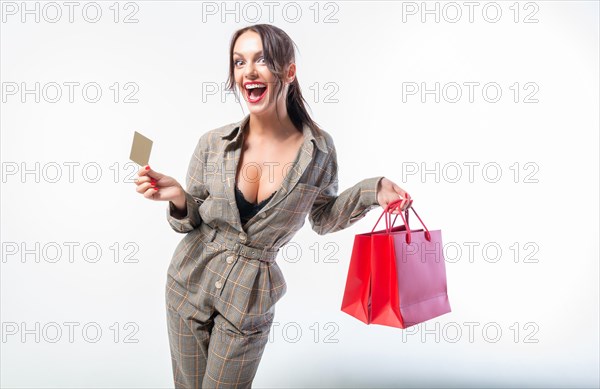 Sexy girl posing with a discount card and red bags. Concept Shopping on Black Friday. White background.