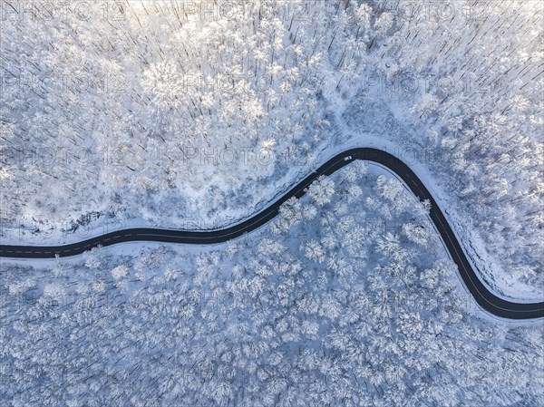 Winding country road near Gutenberg on the Swabian Alb in winter