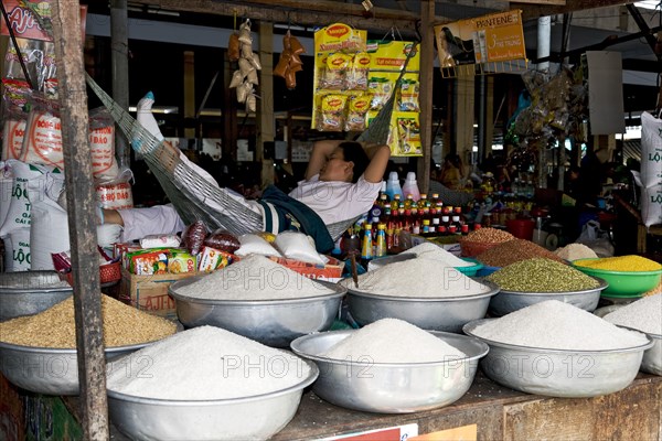 Slumbering market woman and bowls of rice