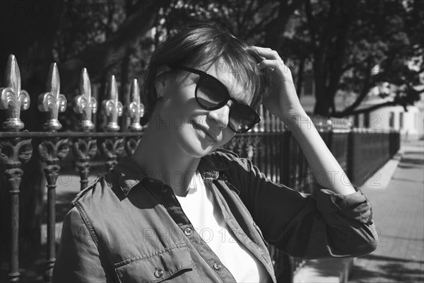 Portrait of a stylish woman in sunglasses. Happiness