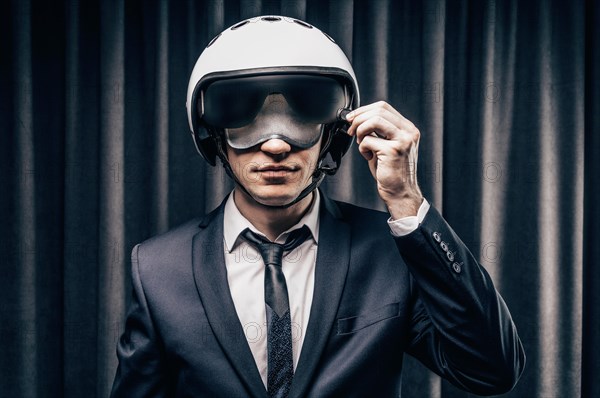 Elegant steward is standing in the cockpit in a helmet. The concept of safe flights. Insurance.