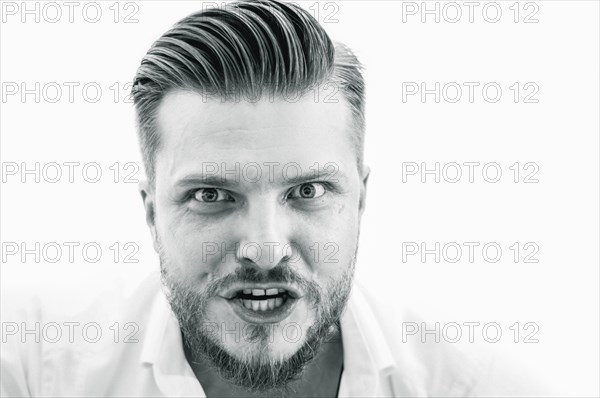 Angry man is very aggressively looking at the camera. Concept of bad work