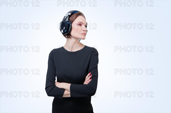 Portrait of a woman in professional headphones. White background. Dj concept.