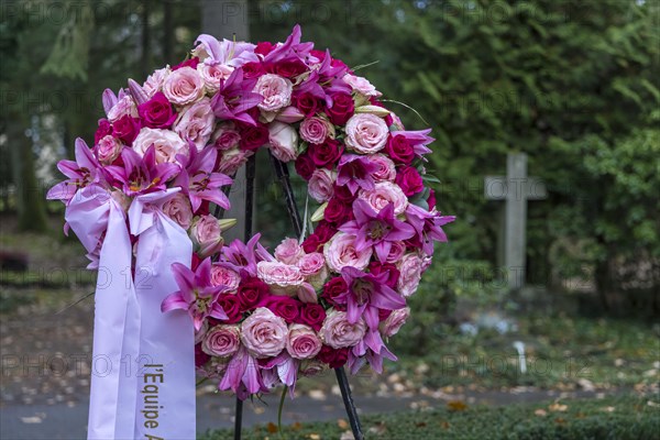 Funeral wreath with flowers at a grave