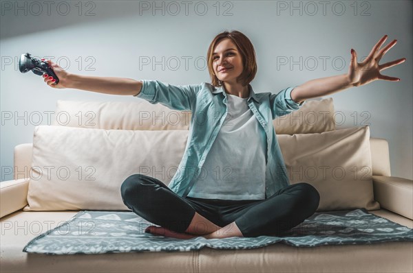 Portrait of a girl with a joystick in her hands. The concept of video games