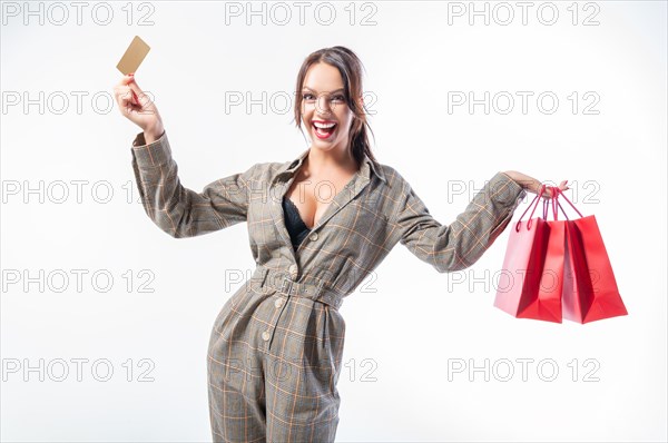 Sexy girl posing with a discount card and red bags. Concept Shopping on Black Friday. White background.