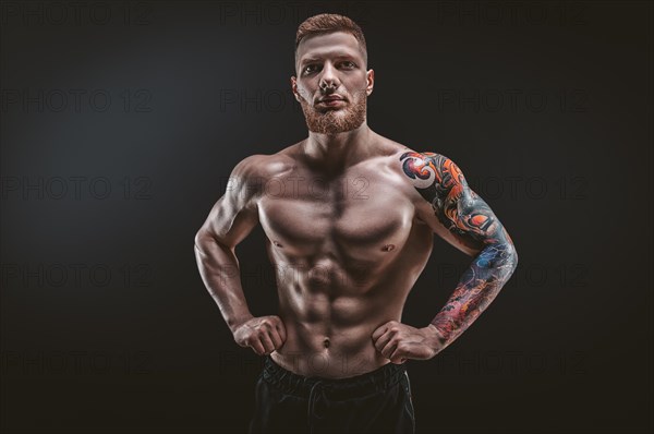 Young muscular guy posing in the studio. Fitness and nutrition concept.