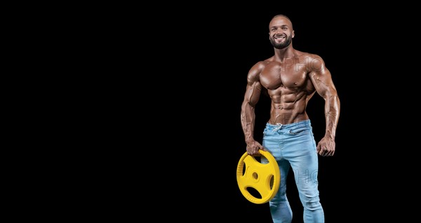Isolated muscular man on a black background. Bodybuilding and fitness concept. Panorama.