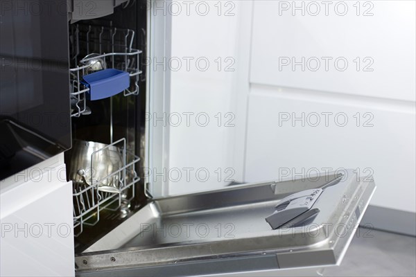 White modern dishwasher in the interior of a white kitchen