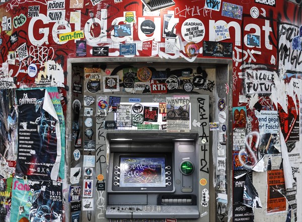 ATM with graffiti and stickers on the RAW site. The RAW site is the former Reichsbahn repair works in the Friedrichshain district. Today