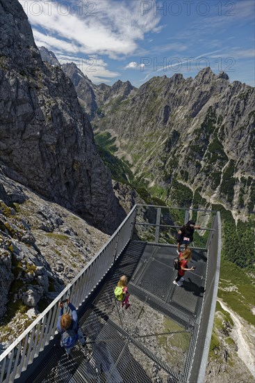People on a viewing platform in the mountains
