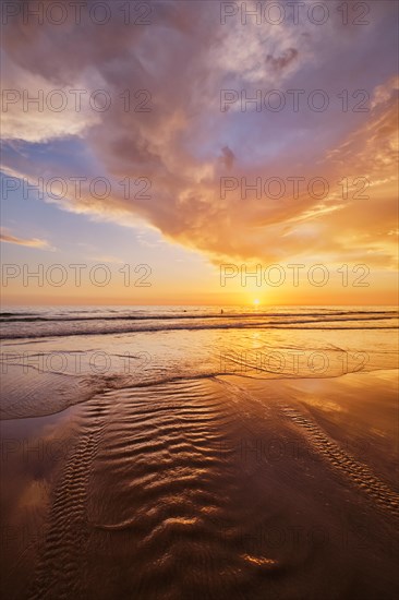 Atlantic ocean sunset with surging waves at Fonte da Telha beach, Costa da Caparica, Portugal,