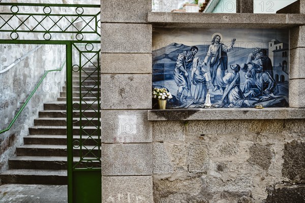 Holy Mary statue with the religious background made of Portuguese traditional tiles, Porto,