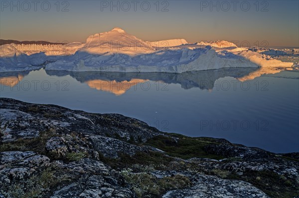Reflection of icebergs, midnight sun, summer, Ilulissat Icefjord, Disko Bay, Jakobshavn Glacier,