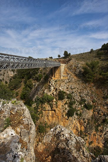 An iron bridge spans a gorge under a blue sky, Aradena Gorge, Aradena, Sfakia, Crete, Greece,