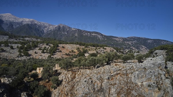 Ruins of old buildings against the majestic backdrop of a mountain, Aradena Gorge, Aradena, Sfakia,