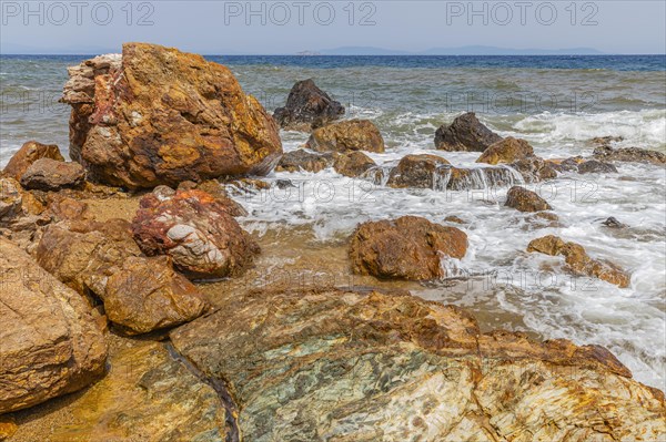 Mineral rocks washed by the sea on the beach of Topinetti, near Rio Marina, Elba, Tuscan