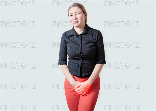 Young woman suffering with urinary problems isolated. Girl with hands on crotch with urinary