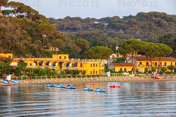 Pedal boats, sun loungers and parasols on the beach at Naregno at sunrise, near Capoliveri, Elba,