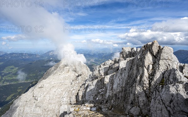 Rocky narrow mountain ridge with summit Watzmann Hocheck, view from Watzmann middle summit to