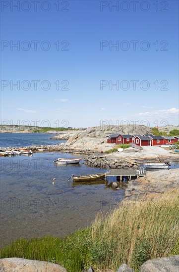 Red wooden houses on the archipelago island of Hoenoe, Oeckeroe municipality, Vaestra Goetalands