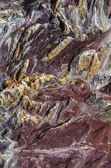 Coloured, ferrous mineral rocks on the beach of Topinetti, near Rio Marina, Elba, Tuscan
