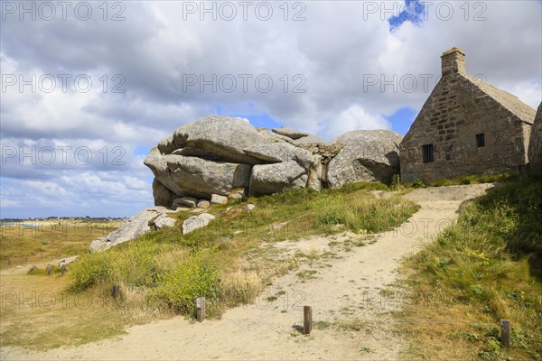 Former village of Meneham on the Atlantic coast with partly thatched houses between granite rocks,