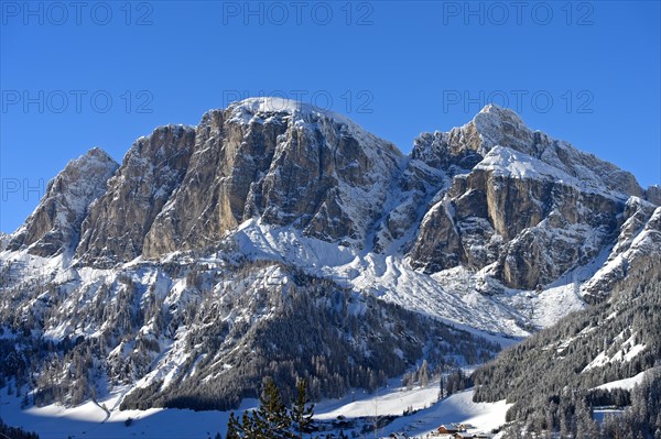 Snow-covered peak Sass de Ciampac above the mountain village of Colfosco, Colfosco, winter sports
