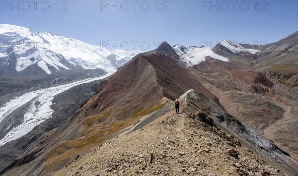 Mountaineer at Traveller's Pass with view of impressive mountain landscape, high mountain landscape